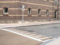 a blue stop sign that is on a street corner near buildings of some sort with windows