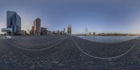 the cityscape of a harbor and buildings as seen in a fish eye lens