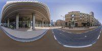 360 - view of street in front of a large building and other structures in the background