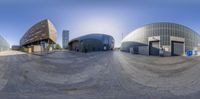 the reflection of three buildings is seen in this fish - eye shot taken from a 360 camera