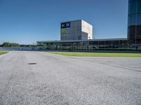 a person on a skateboard is doing a trick in front of a building in an airport