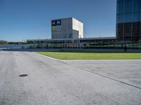 a person on a skateboard is doing a trick in front of a building in an airport