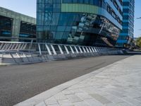 people on skateboards ride across the bridge outside a building that says chase labs, with some stairs in the foreground