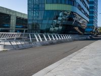 people on skateboards ride across the bridge outside a building that says chase labs, with some stairs in the foreground