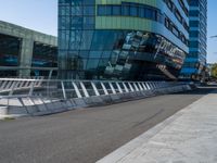 people on skateboards ride across the bridge outside a building that says chase labs, with some stairs in the foreground