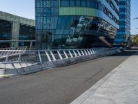 people on skateboards ride across the bridge outside a building that says chase labs, with some stairs in the foreground