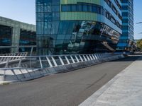 people on skateboards ride across the bridge outside a building that says chase labs, with some stairs in the foreground