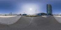 a fish eye shot of a skateboard ramp in front of a building that says a stadium