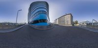 the curved street and building are shown with a clear sky above them in a panorama