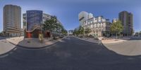 a view of an empty city street from the fish - eye lens on a sunny day