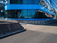 a skateboarder doing tricks in front of a building with many windows on the side