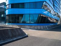 a skateboarder doing tricks in front of a building with many windows on the side