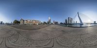 a fisheye lens looking into an area with buildings and a river in the background