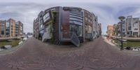 a fish - eye lens lens photo of an old canal and modern buildings in a city