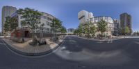 a circular panorama of a street with buildings in the background and a few bicycles parked along a street