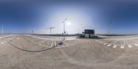 a panoramic view of a roundabout with a city in the background on a sunny day