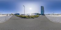 a view of buildings through a fish eye lens at a city park of an intersection