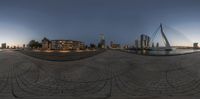 the circular photograph is on the edge of a walkway and in front of the city skyline