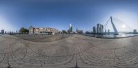 an image of a fish eye view from the water area of a city at sunrise