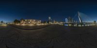 a fish eye view from the water's edge, with buildings in the background