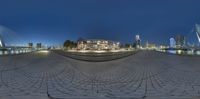 a fish eye view from the water's edge, with buildings in the background