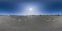 a photo of the street taken with fisheye lenses in a parking lot on the water