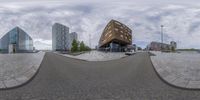 this photo shows a closeup of some buildings and a skate board park, taken from a fisheye