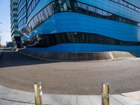 a blue building with silver poles around it by itself outside it looks like a building