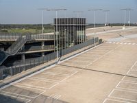 two parking lanes on an outside runway between the road and street with staircases to the right