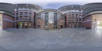 a fish eye view of some modern buildings and stairs in front of them on a sunny day