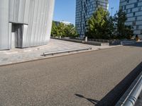 a skateboarder riding the rails outside of a building near other buildings and trees