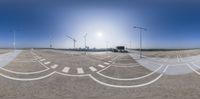 there are street lights that point towards an airport road with the runway in view behind them