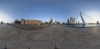 the view from a spherical mirror of a building in the city with skyscrapers in the distance