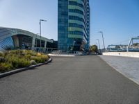 a very tall building with two huge windows on the side of it and some cars