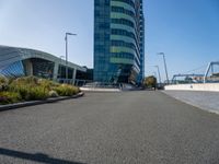 a very tall building with two huge windows on the side of it and some cars