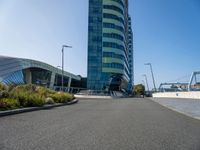 a very tall building with two huge windows on the side of it and some cars