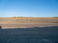 an empty airport runway and road with a message on it in english, saying goodbye