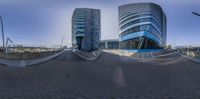 a reflection in the middle of the road on a sidewalk while traffic crosses a bridge with modern buildings behind