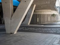 a parking garage with concrete pillars and columns that have been carved into the side of the building