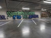 a parking garage with graffiti on the wall and two skateboards leaning up against each other