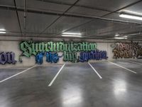 a parking garage with graffiti on the wall and two skateboards leaning up against each other