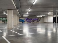 the empty parking garage has been transformed into a work - space for skateboarding enthusiasts