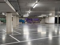 the empty parking garage has been transformed into a work - space for skateboarding enthusiasts