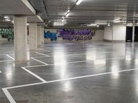 the empty parking garage has been transformed into a work - space for skateboarding enthusiasts