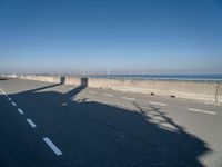 the shadow of a person on a skateboard on a highway with a sign in the distance