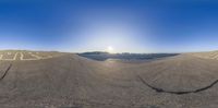 the view of a sand mountain and sun shining in the background, with one of the images split into half