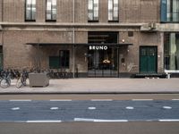 bicycle parked next to a building on a city street with a sign that says brunno