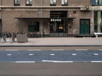 bicycle parked next to a building on a city street with a sign that says brunno