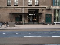 bicycle parked next to a building on a city street with a sign that says brunno