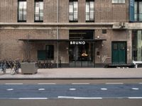 bicycle parked next to a building on a city street with a sign that says brunno